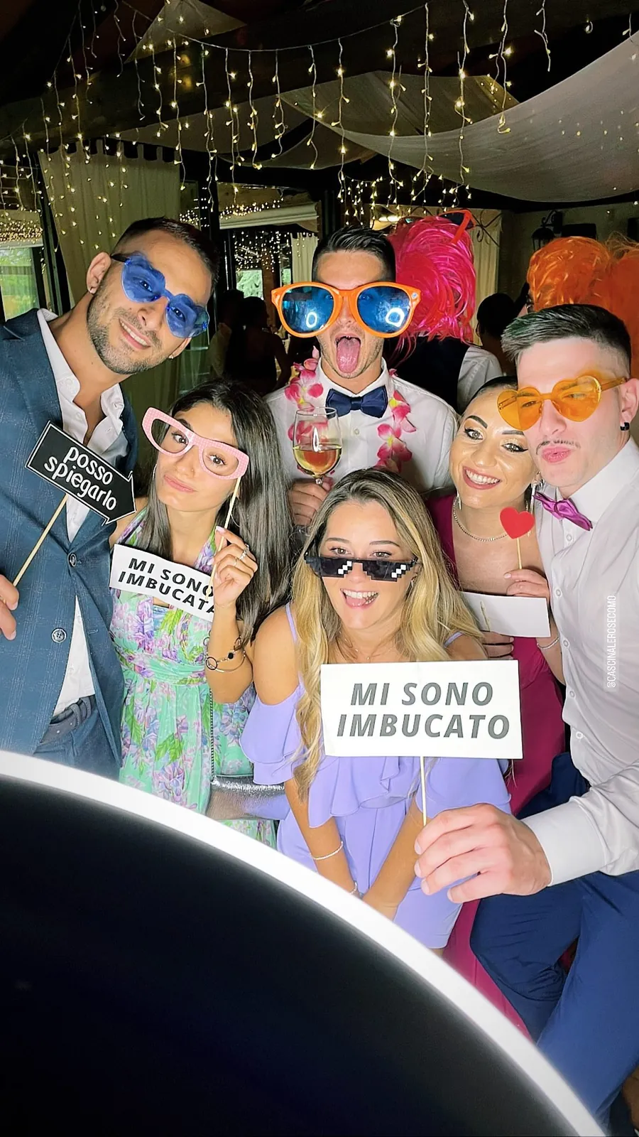 Photo booth at a wedding: guests and the couple