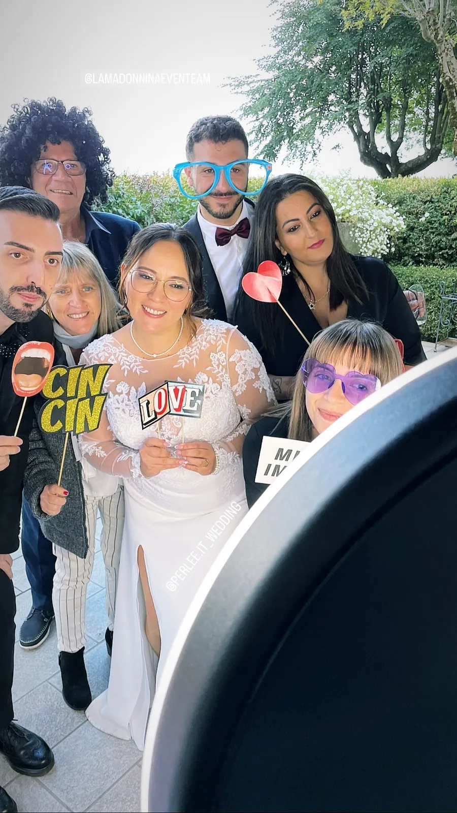 Photo booth at a wedding: guests and the couple