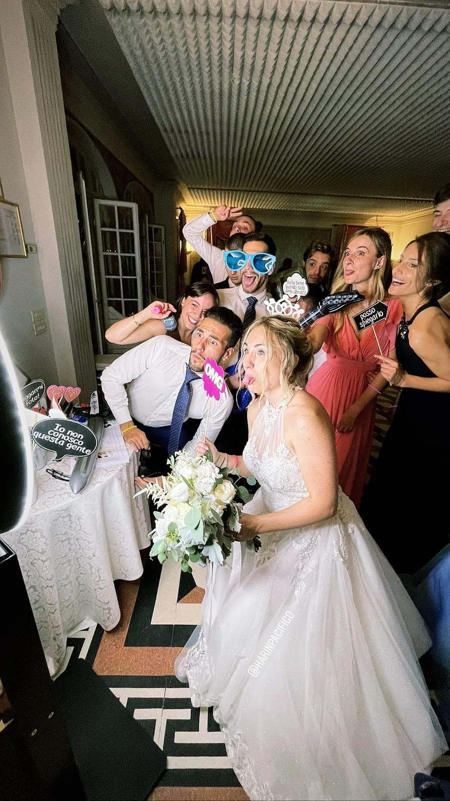 Photo booth at a wedding: guests and the couple