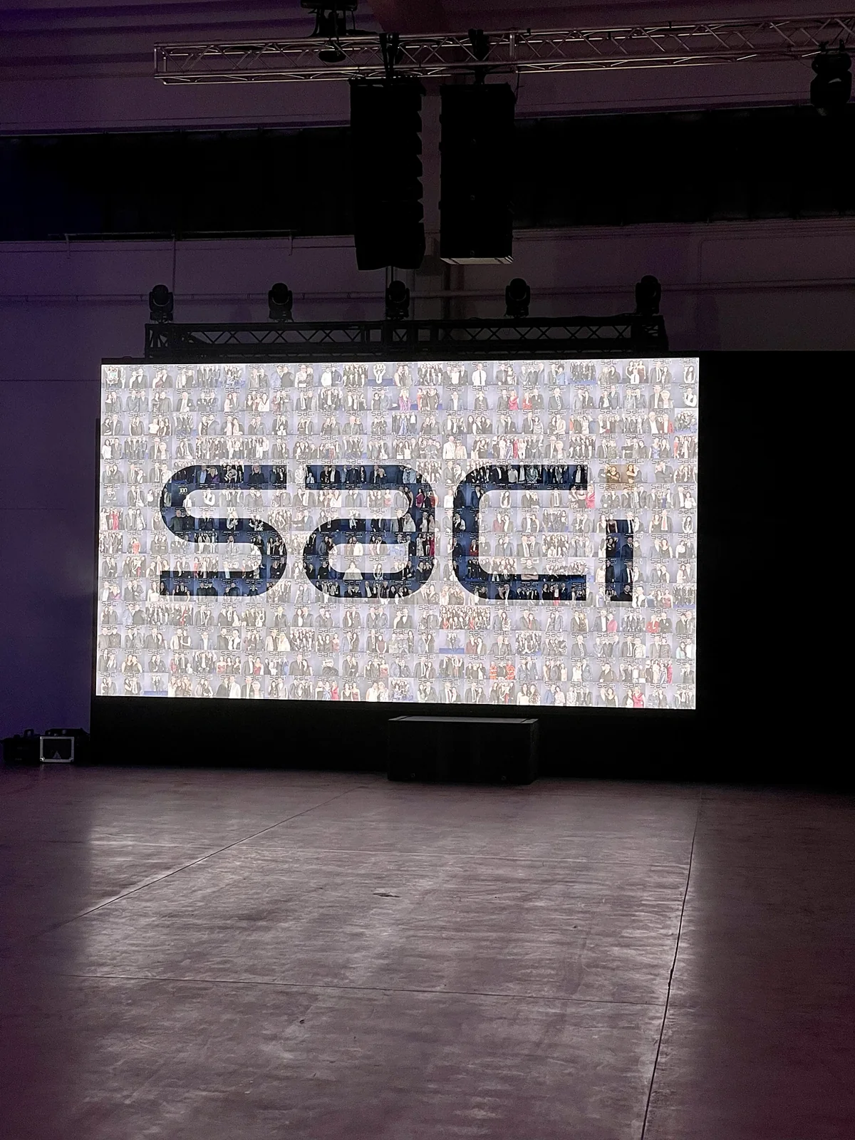 Photo mosaic with guests’ photos forming the company logo on an LED wall